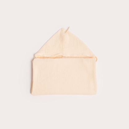neatly folded cream organic hooded children's towel