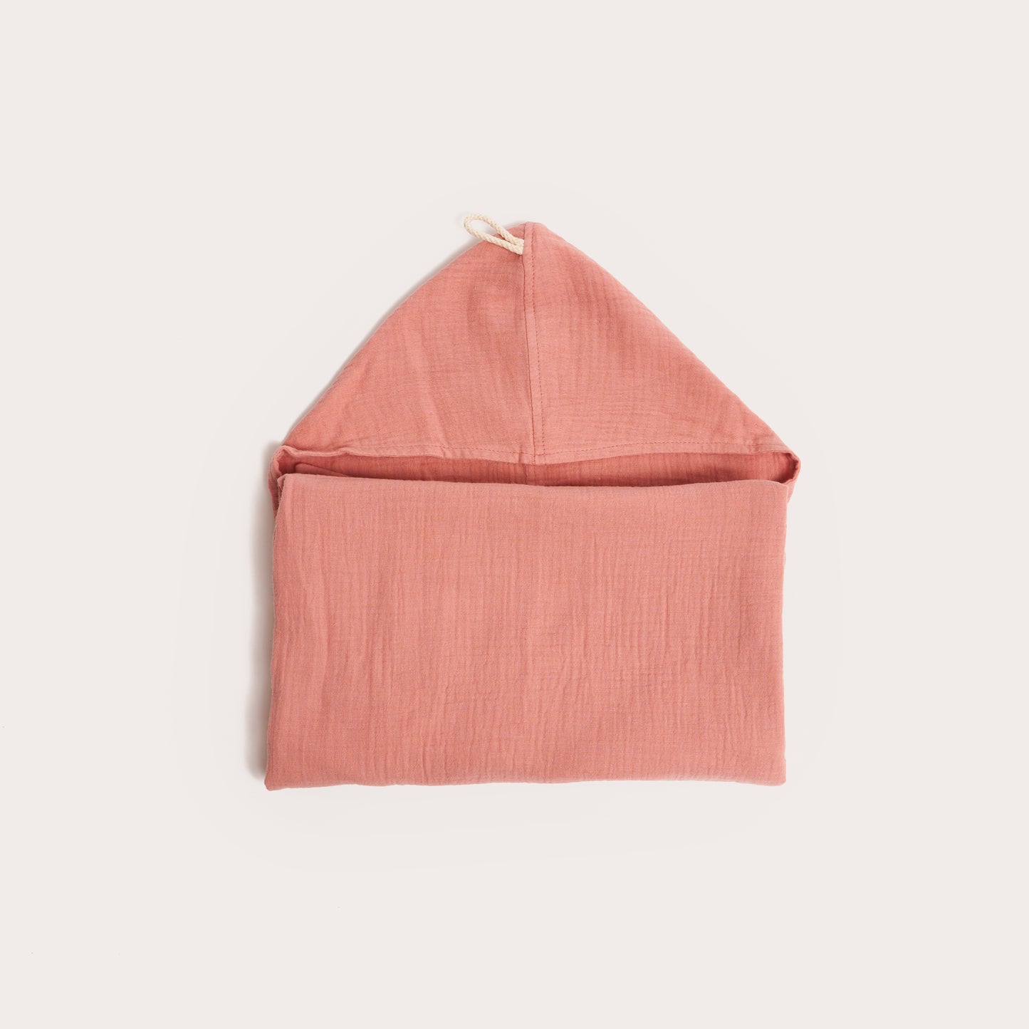neatly folded dusk pink organic hooded cotton children's towel