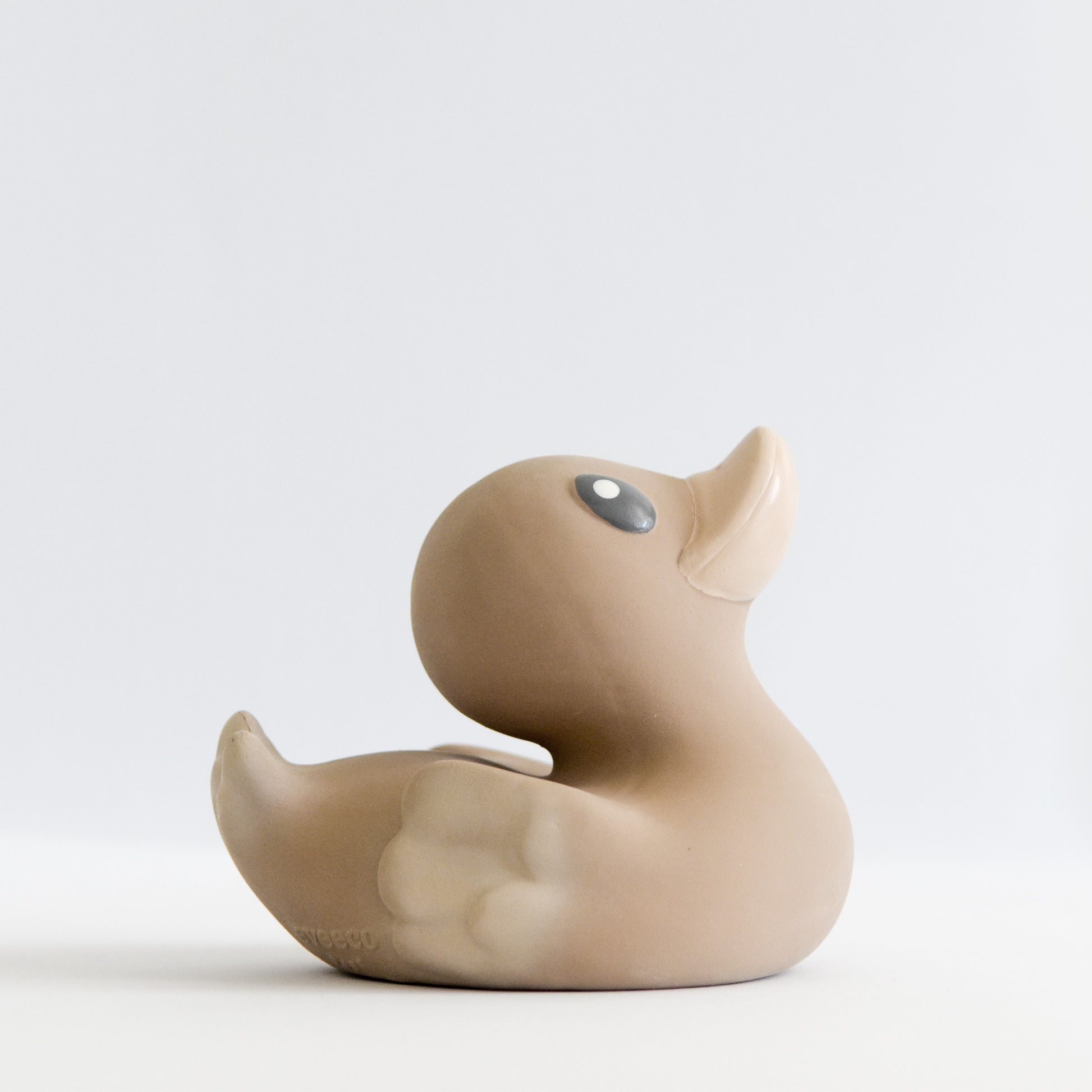 side view of an adorable natural rubber bath toy duck in a chocolate colour