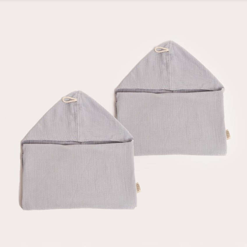 two neatly folded light mist blue organic hooded cotton children's towel