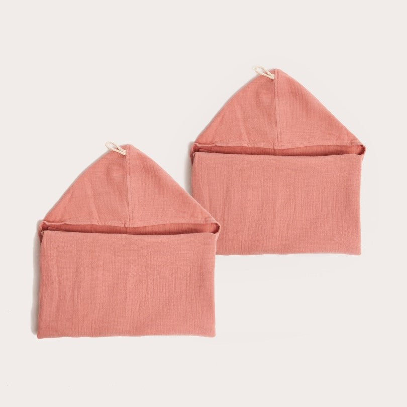 two neatly folded dusk pink organic hooded cotton children's towel