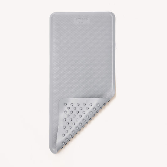 large grey natural rubber non-slip bath mat for a child to use in a bath to keep them safe